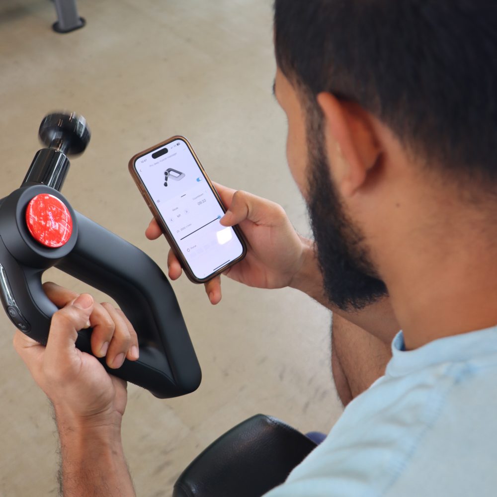 Man in Gym Handle with Mobile D5 PRO Massage Gun